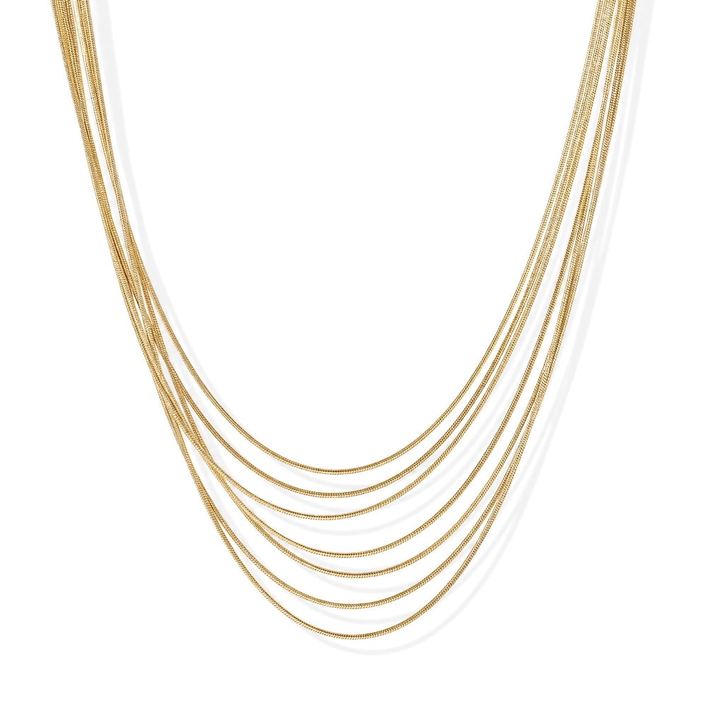 Seven delicate gold-plated snake chains create an elegant layered necklace on a neutral background.
