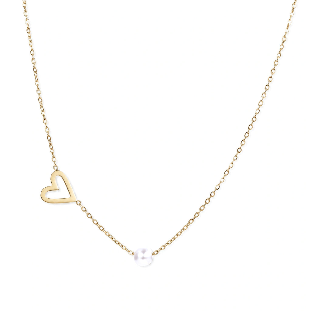Dainty 14K gold plated stainless steel necklace with an open heart charm and a single round white bead on a cream background.