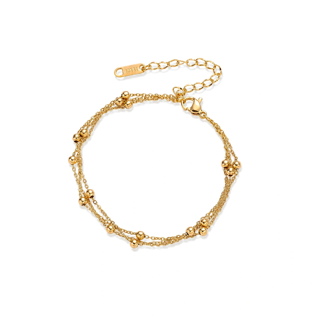 Three-strand gold-plated bracelet with clustered ball beads and adjustable clasp on cream background