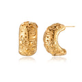 Wide gold hoop earrings with embossed stars and sun motifs on cream background, showing dimensional relief details.