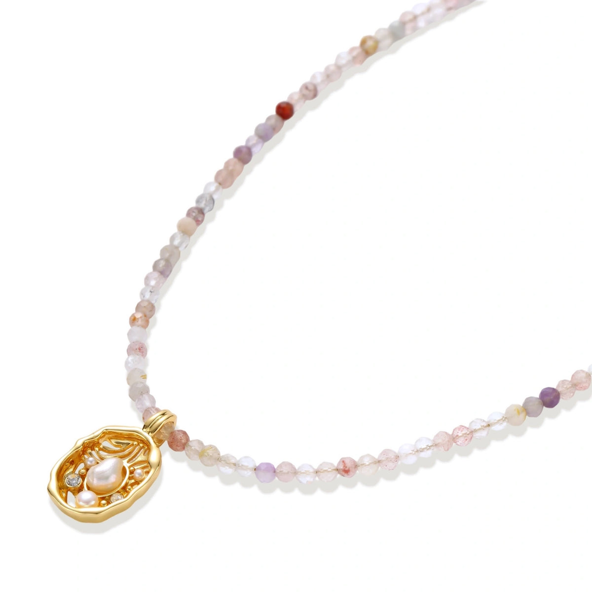 Delicate gold-plated necklace with mixed gemstone beads and ornate oval pendant on white background