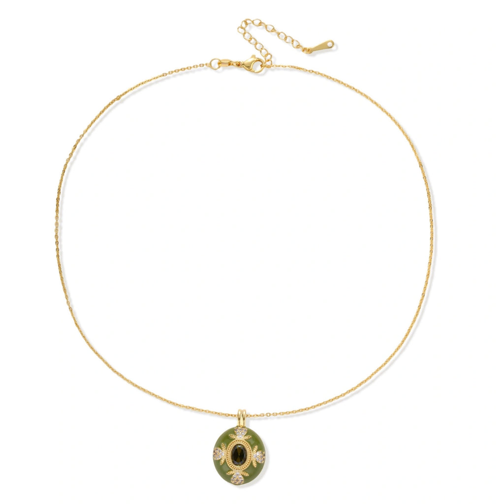 Gold-plated pendant necklace with green enamel background and oval olive cubic zirconia center stone with crystal accents.
