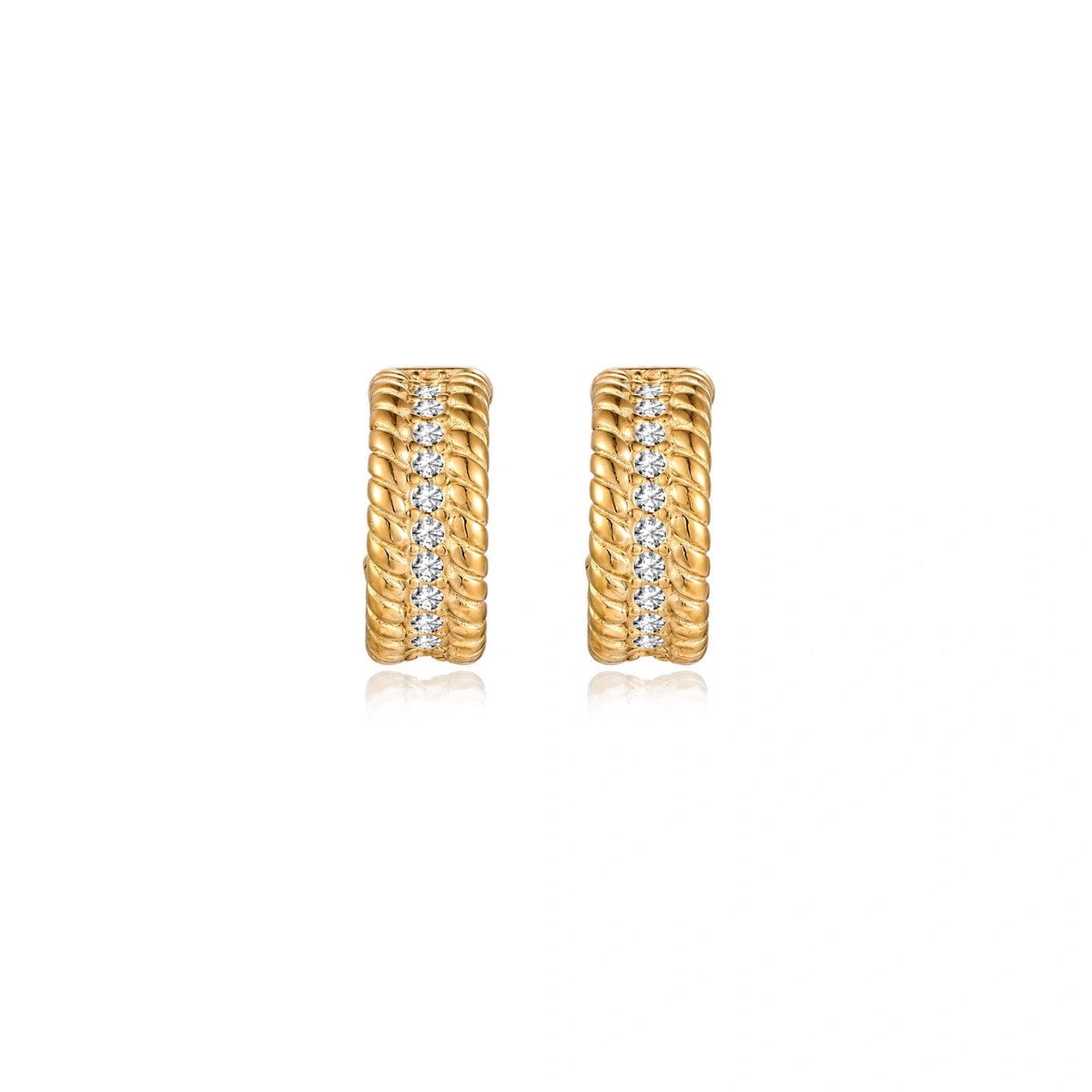 Textured gold huggie hoop earrings with raised ribbed rows creating dimensional sculptural design on cream background