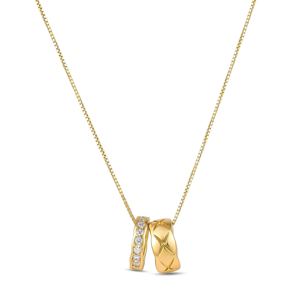 Gold box-chain necklace with two interlocking ring pendants — one star-engraved, one pavé cubic zirconia, 18K gold-plated.